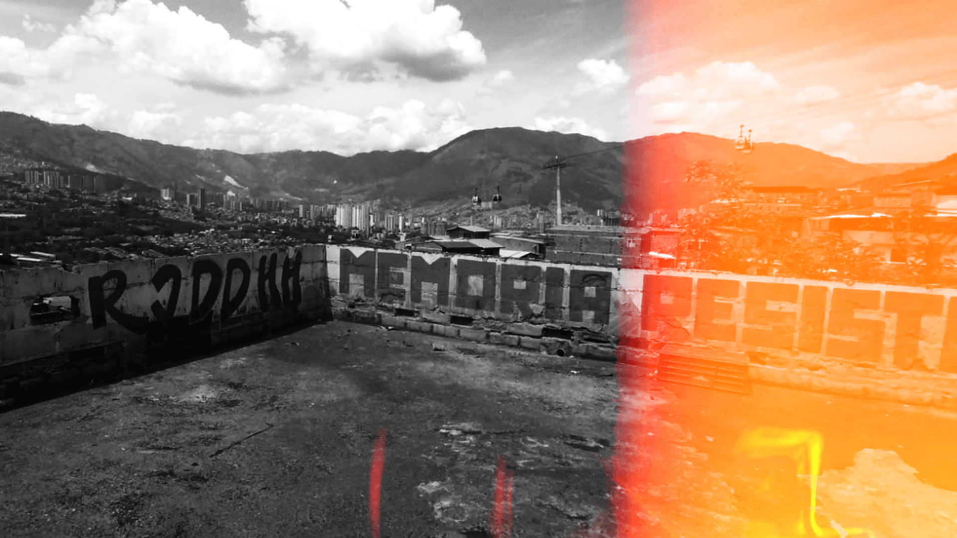 Fotografía. Desde una terraza se ve en blanco y negro y con un color naranja de rollo fotográfico velado el paisaje nororiental de Medellín: edificios pequeños y altos residenciales, el metrocable, la cadena montañosa que encierra el Área Metropolitana y las nubes que transitan el día que tomaron la fotografía. 