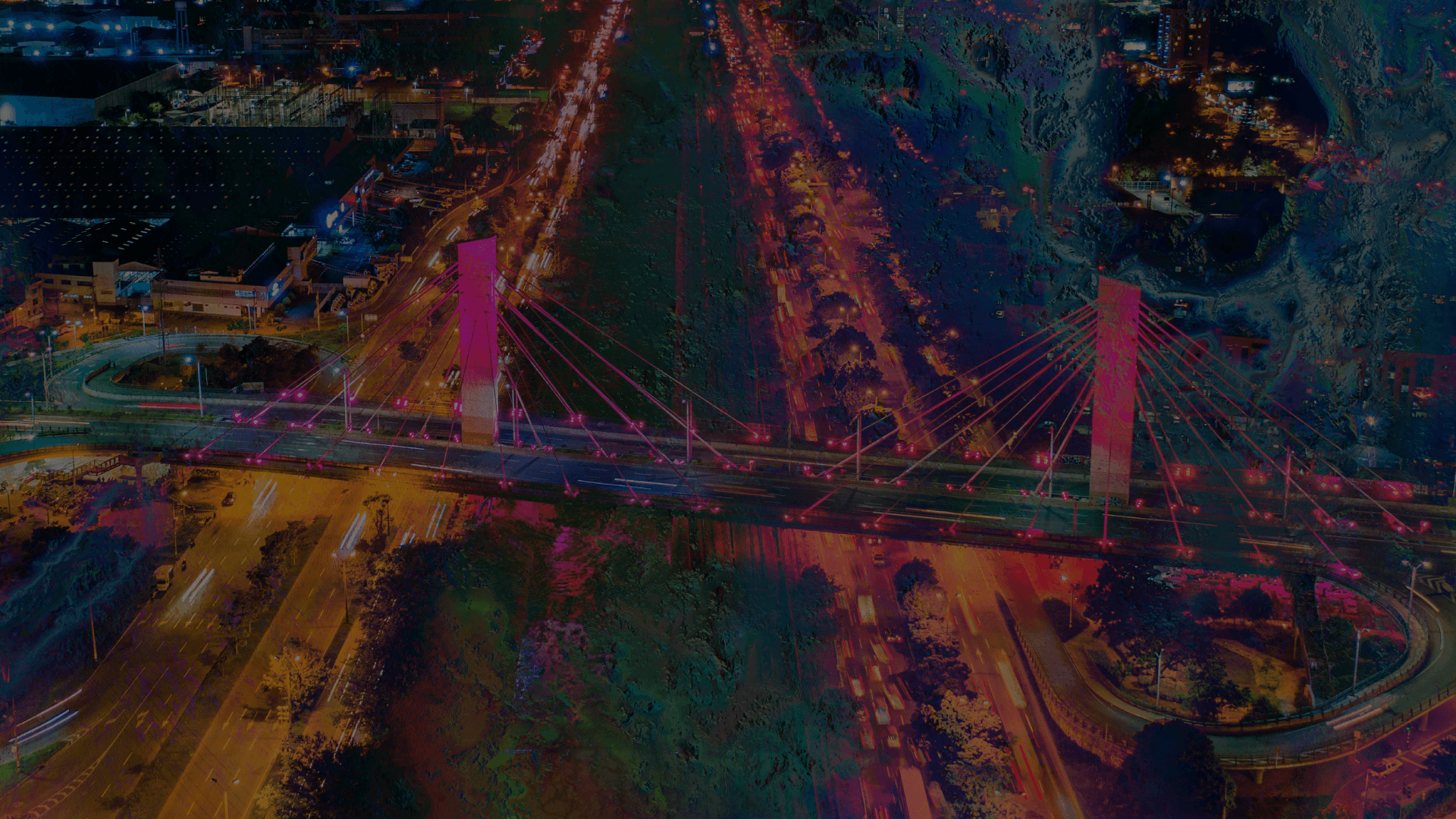 Fotografía. Plano general de una ciudad. Las casas, los edificios, los puentes, los árboles y demás estructuras y elementos que conforman la ciudad tienen una textura de colores fluorescentes.