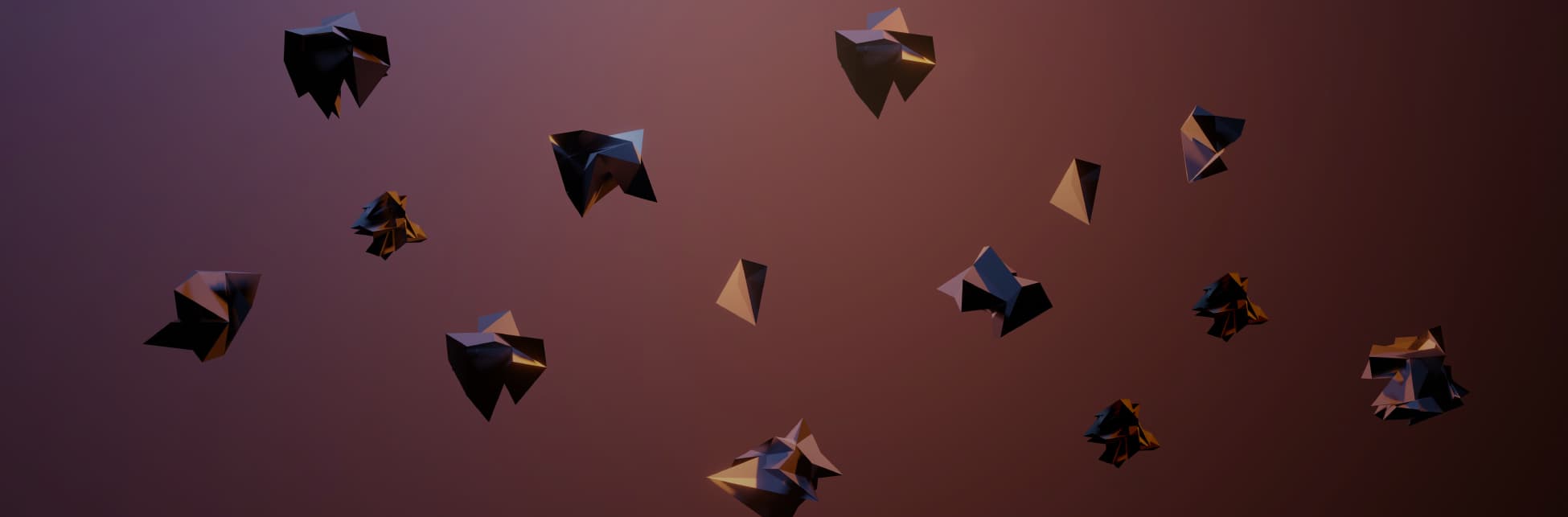 Foto. Sobre un fondo en tonos vinotinto varias figuras de origami.