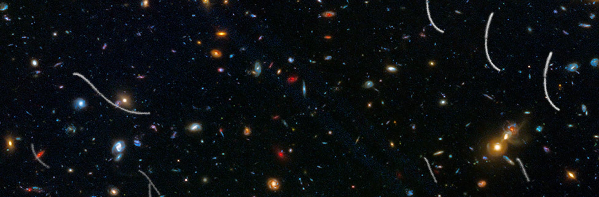 Fotografía del espacio con múltiples galaxias y puntos de luz sobre un fondo oscuro.