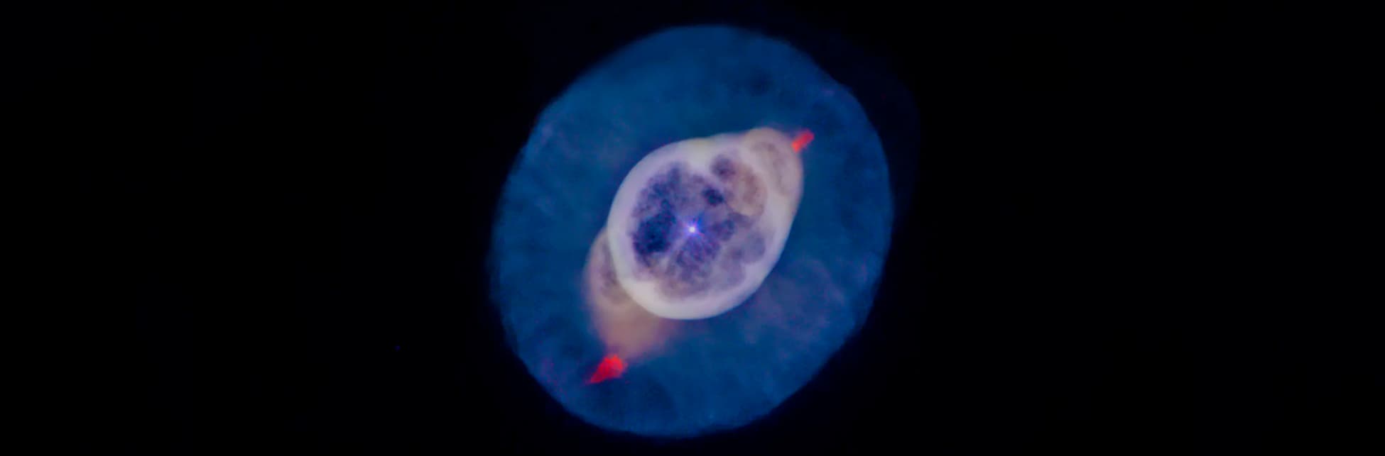 Imagen digital. Una estrella rodeada de círculos asimétricos que van aumentado su tamaño y cambian de color.